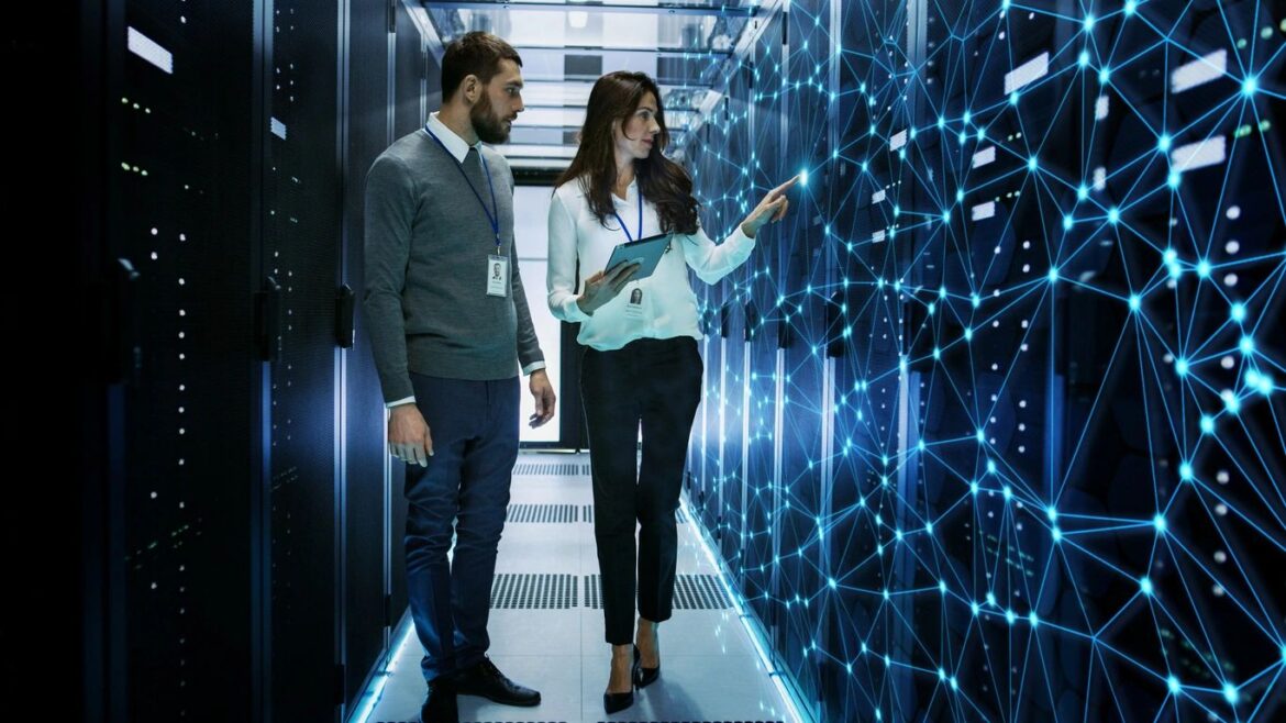 IT professionals reviewing a digital network in a data center, representing sovereign cloud infrastructure